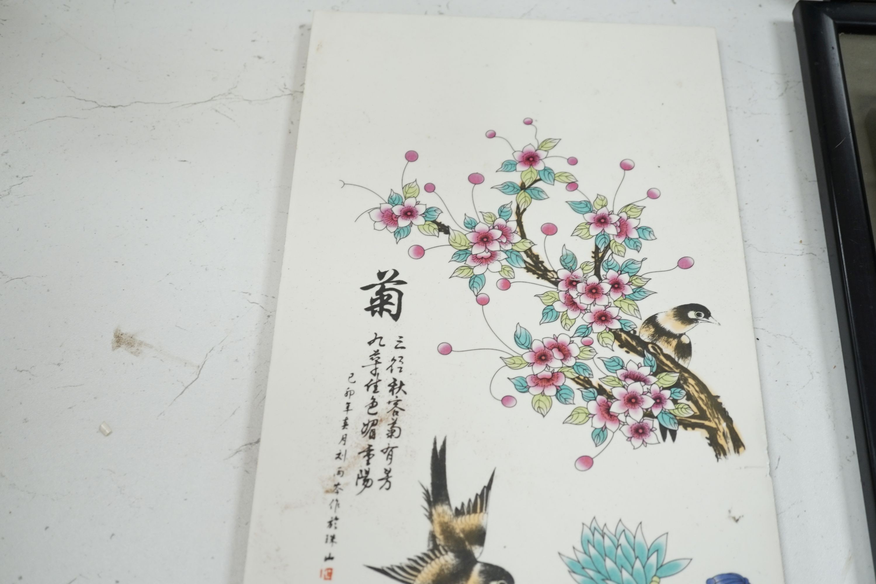 A Chinese enamelled tile, decorated with birds and flowers, 75 cms high x 22 cms wide.